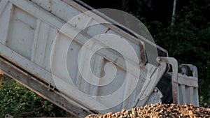 Dumping of soil using the dump truck and truckload of Gravel