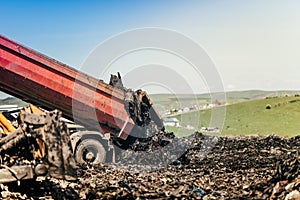 Dumping truck getting trash moved on construction site