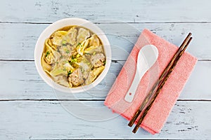Dumpling pork soup with spoon and chopstick