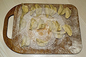 Dumplings on a board in flour. photo