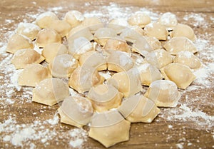 Dumplings cooked at home. Raw blinded dumplings on the table. A dish for Valentine`s Day. DIY. Step by step. Step 6