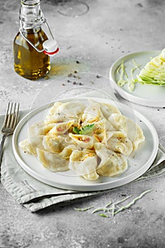 Dumplings, filled with cabbage. Russian, Ukrainian or Polish dish: varenyky, vareniki, pierogi, pyrohy. Food photo