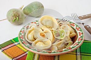 Dumplings with green radish, bacon and fried onions