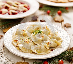 Dumplings with mushroom cabbage filling on a white plate.