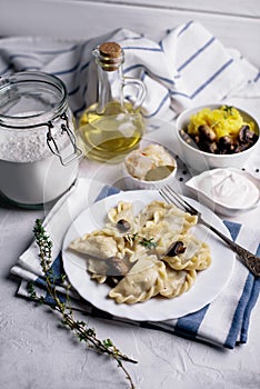 Dumplings with mushrooms, potatoes, cabbage and sour cream