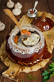 Dumplings in a pot on a wooden table