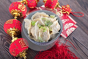 Dumplings, red envelopes and lantern decorations in Chinese festivals. The Chinese characters in the picture mean `happiness` and