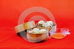 Dumplings are served on bamboo tray, ready to be enjoyed.
