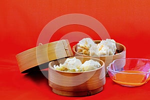 Dumplings are served on bamboo tray, ready to be enjoyed.