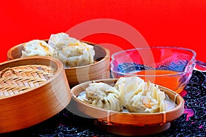 Dumplings are served on bamboo tray, ready to be enjoyed.