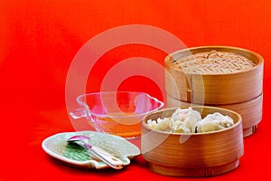 Dumplings are served on bamboo tray, ready to be enjoyed.