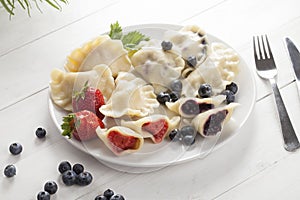 Dumplings with strawberries and blueberries