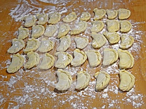 Dumplings on the yellow kitchen board