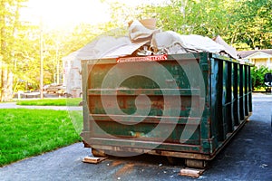 Dumpsters being full with garbage in a city.