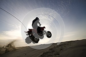 Dune atv jump in the sunset
