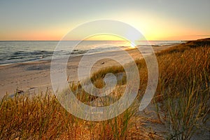 Dunes on the coast of the Baltic Sea, sunrise on the beach on a summer day.