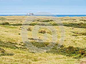 Dunes of nature reserve Het Oerd and offshore platform in North Sea off coast of West Frisian island Ameland, Friesland,