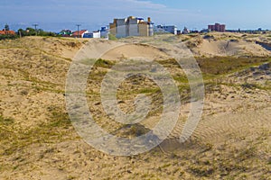 Dunes, vegetation and buildings at Cassino beach