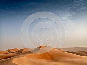 The dunes of the Wahiba Sands desert in Oman at sunset during a