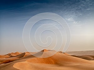The dunes of the Wahiba Sands desert in Oman at sunset during a photo