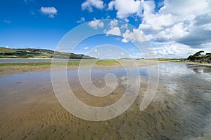 Dunfanaghy Bay at low tide in Donegal, Ireland. White sand and blue sky with clouds at Dunfanaghy beach, a typical irish beach on photo