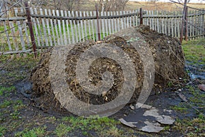 Dung heap on land with trees