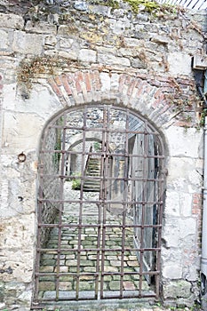 A dungeon looking old building with iron grills