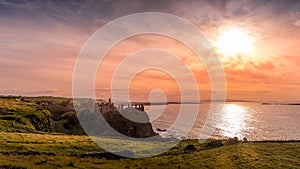 Dunluce Castle on the cliff in Bushmills, sunset