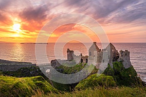 Dunluce Castle on the cliff in Bushmills, sunset