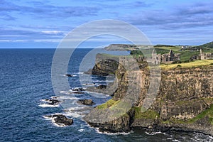 Dunluce Castle located on the edge of a basalt outcropping, Count Antrim, Northern Ireland