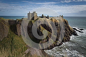 Dunnottar Castle on top of a cliff by the sea on a cloudy day, Stonehaven, Scotland, United Kingdom