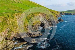 Dunquin or Dun Chaoin pier, Ireland\'s Sheep Highway. Aerial view of narrow pathway winding down to the pier