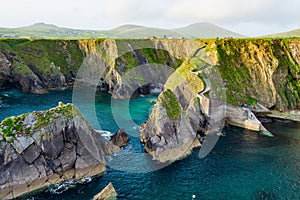 Dunquin or Dun Chaoin pier, Ireland\'s Sheep Highway. Aerial view of narrow pathway winding down to the pier