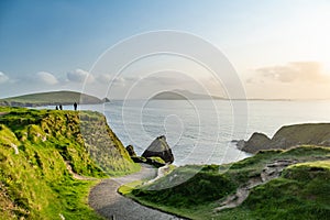 Dunquin or Dun Chaoin pier, Ireland\'s Sheep Highway. Narrow pathway winding down to the pier, ocean coastline, cliffs