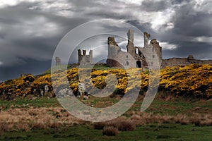 Dunstanburgh Castle is a 14th-century fortification on the coast of Northumberland. sky adjusted.