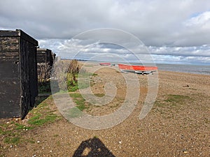 Dunwich beach Suffolk boats thriving town once sheds with winch gear inside 2020 coastal town