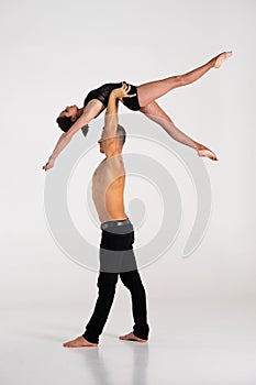 Duo Of Acrobats Showing hand to hand Trick, Isolated On White