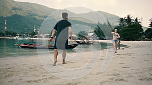 Duo playing on the beach in badminton