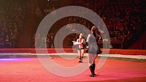 The Duo of Twin Girls Juggle with Clubs Performs Tricks on the Circus Stage