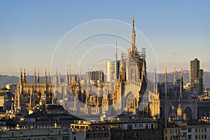 Duomo di Milano with Milan Skyline and alps on background at dawn