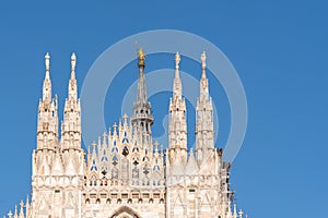 Duomo Milan details with golden staute Madonnina close up