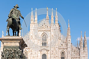 Duomo Milan details with golden staute Madonnina and Vittorio Emanuele statue