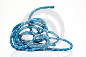durable colored rope for climbing equipment on a white background. climbing rope. coil of braided cable. item for tourism and