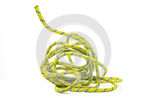 durable colored rope for climbing equipment on a white background. climbing rope. coil of braided cable. item for tourism and