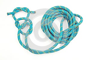 Durable colored rope for climbing equipment on a white background. knot of braided cable. item for tourism and travel