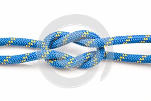 Durable colored rope for climbing equipment on a white background. knot of braided cable. item for tourism and travel