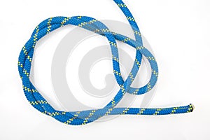 Durable colored rope for climbing equipment on a white background. knot of braided cable. item for tourism and travel