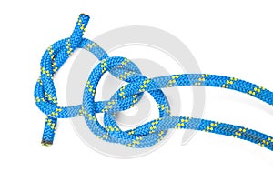 Durable colored rope for climbing equipment on a white background. knot of braided cable. item for tourism and travel