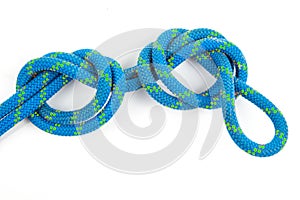 durable colored rope for climbing equipment on a white background. knot of braided cable. item for tourism and travel