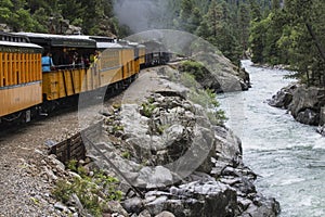 Durango and Silverton Narrow Gauge Railroad Steam Engine travels along Animas River, Colorado, USA